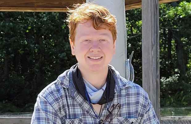 Participant Theresa - person with short red hair smiling outside