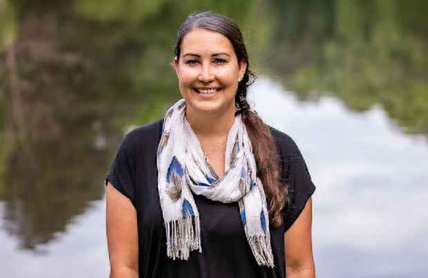 Participant Jenna standing in front of a lake