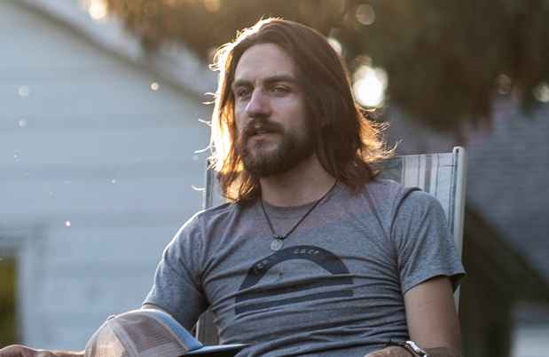 Participant Travis - person with long dark hair sitting outside