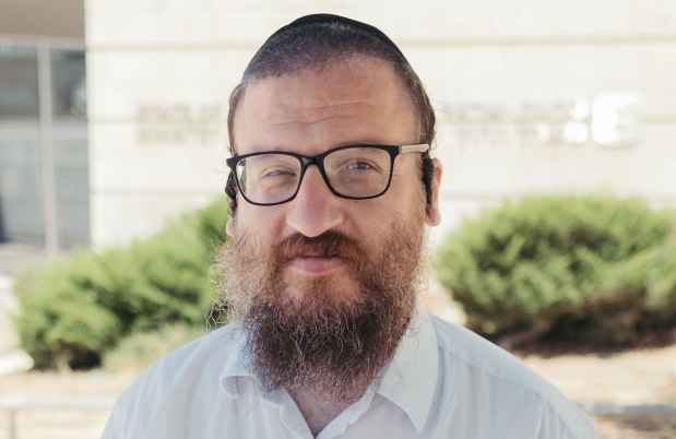 Deconstructing Stigma participant Yakov - Person in white shirt stands outside