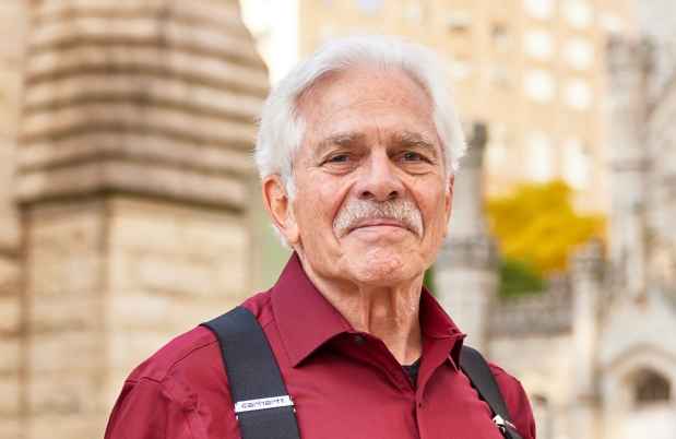 Participant Al - person with short white hair and a red shirt standing outside