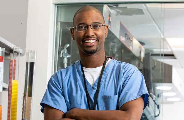 Participant Charles - person with very short hair and glasses wearing blue scrubs