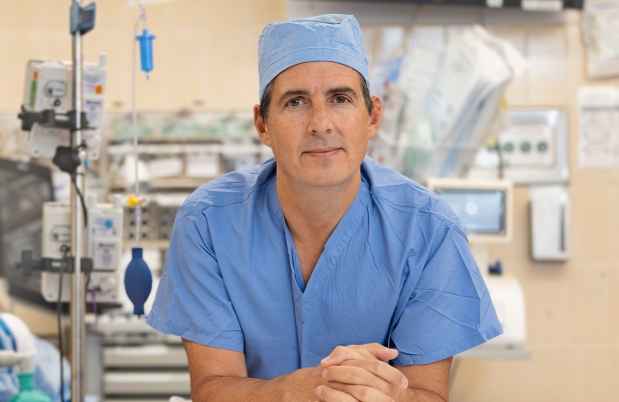 Participant Jeremy - person wearing blue medical scrubs in a room with medical equipment