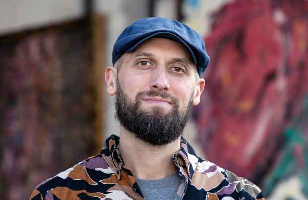 Participant Edmund - person with dark facial hair wearing a dark hat and a colorful patterned shirt