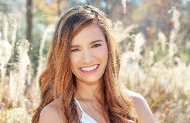 Participant Cali - person with long wavy hair smiling