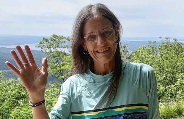 Participant Dani - person with long dark hair smiling outside