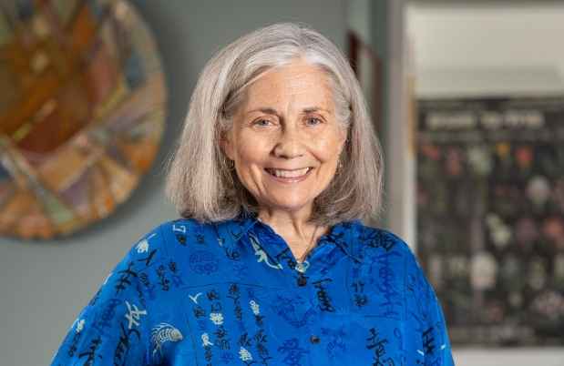 Participant Cynthia - person with grey hair wearing a blue shirt and smiling