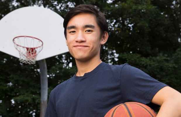 Participant Joel - person with short dark hair smiling outside with a basketball