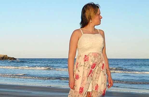 Participant Brittany on the beach staring at the ocean