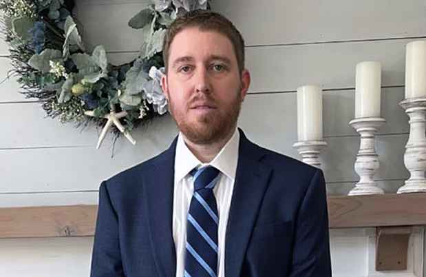 Participant Mike wearing a dark blue suit and tie