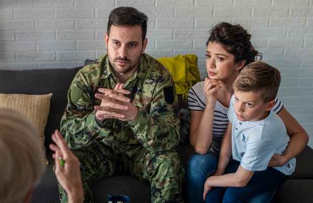 Military family on couch talks to therapist