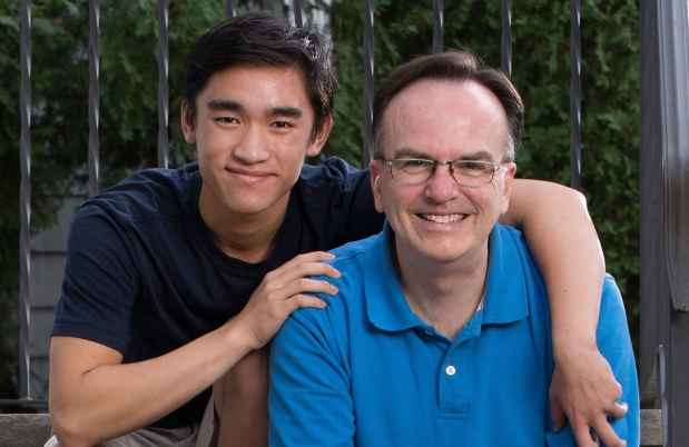 Participant Paul and participant Joel - two people wearing blue shirts sitting and smiling