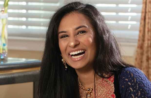 Deconstructing Stigma participant Vaidehi - young woman sits on floor laughing
