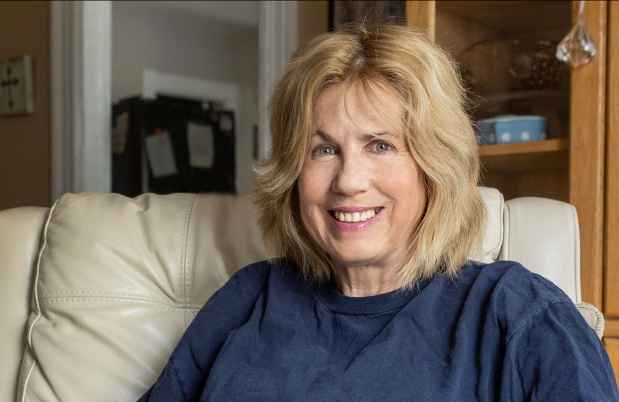 Deconstructing Stigma participant Lisa - Woman sits in chair