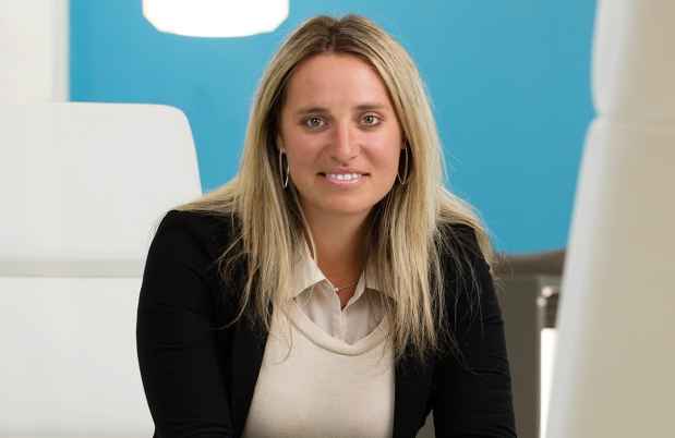 Deconstructing Stigma participant Jessica - person sits in white chair in business office