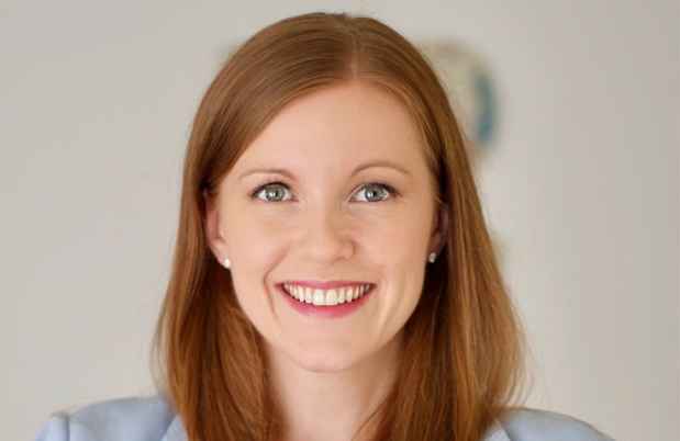Deconstructing Stigma participant Andrea - long red hair and pale blue blazer