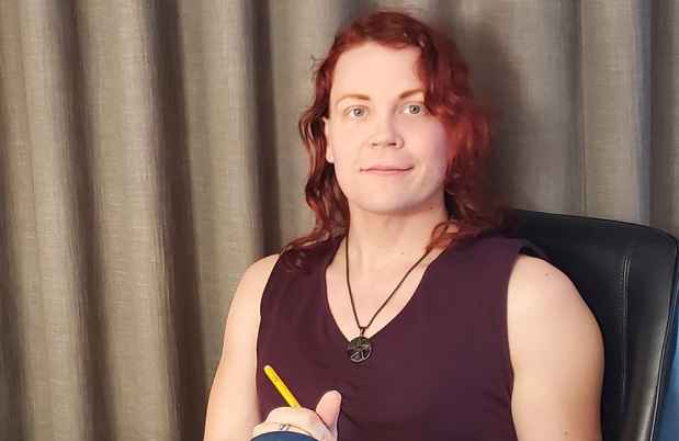 Participant Madison - person with red hair in a burgundy tank top