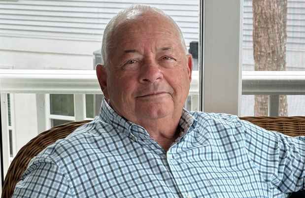 Deconstructing Stigma participant John - person in plaid shirt sits on porch