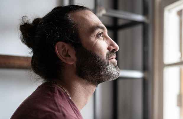 Contemplative person looks out window
