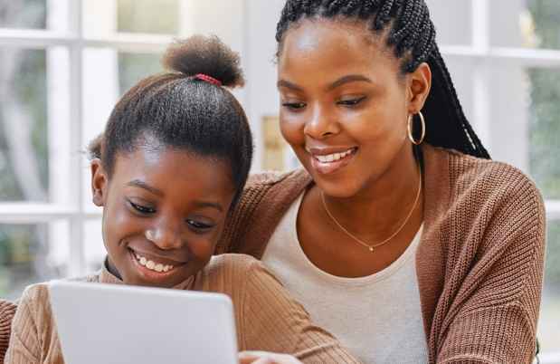 Mom and kid look at tablet together