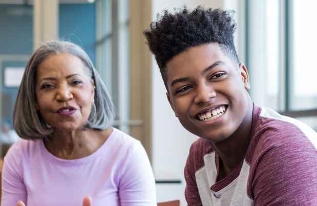 Teen boy and older woman in group therapy