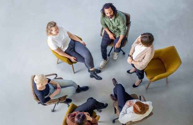 Aerial view of a group of people sitting in chairs in a circle