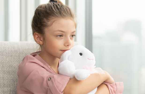Young girl holding a stuffed toy