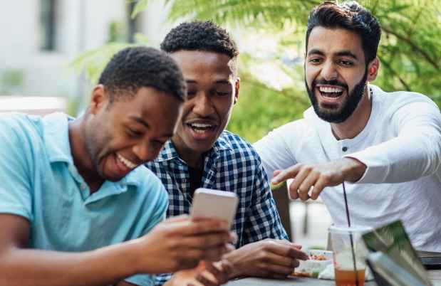 Men hanging out together at outside table