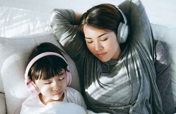 Mom and daughter listening to headphones
