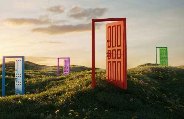 Colorful open doorways scattered in a meadow