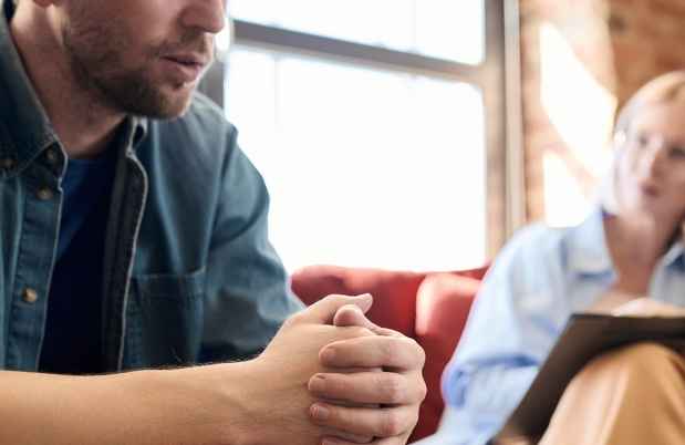 Man sits in therapy session