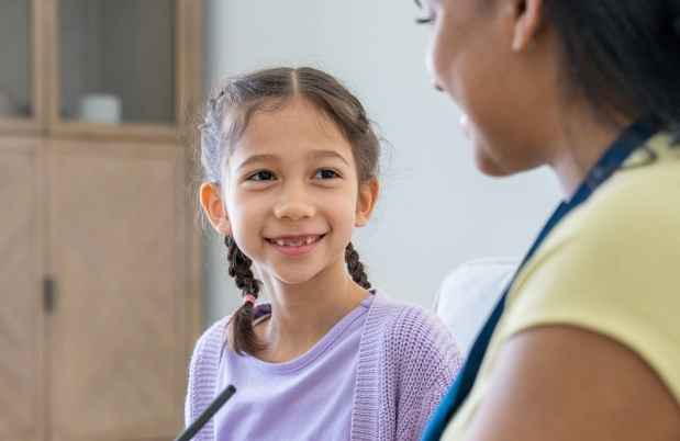 Clinician and young girl talking