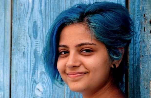 Girl with blue hair looking at camera