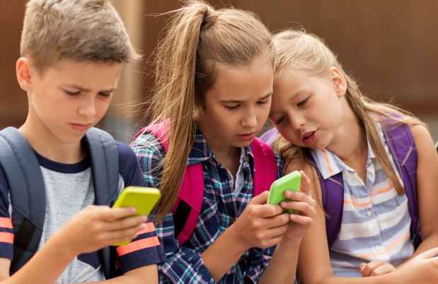 Kids at school looking at phones