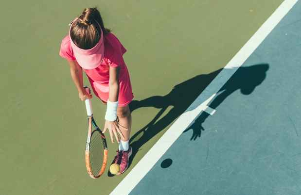 Aerial view of a girl bouncing a tennis ball