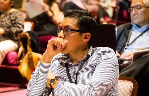 Adults sit in auditorium learning