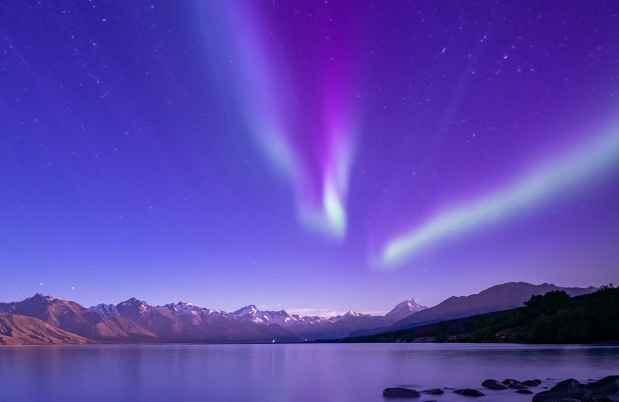 Purple night sky over mountain and lake