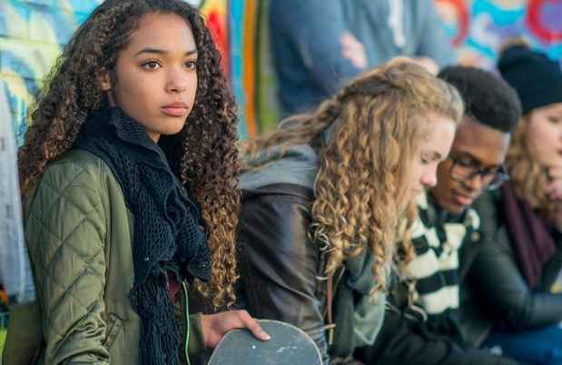 Teens sit outside in cool weather