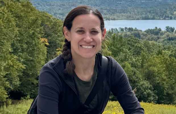 Deconstructing Stigma participant Lauren - person poses with lake, trees in background