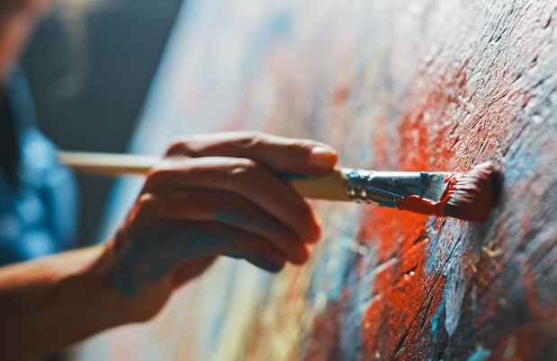 Hand with paintbrush painting