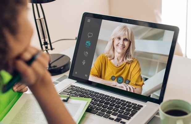 Person watching person on laptop screen