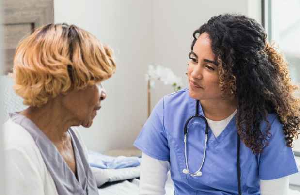 Patient and provider speak in an exam room