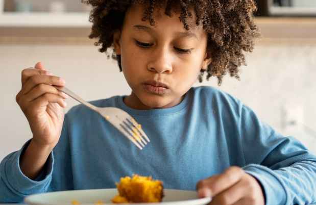 Kid with fork eating