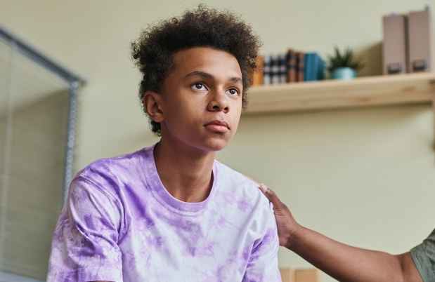 Youth looks out with adult