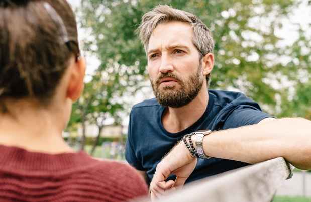 Parent talks with teen outside