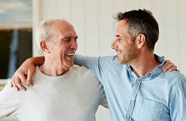 Man and older man with arms around shoulders