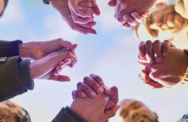 Hands holding in a huddle