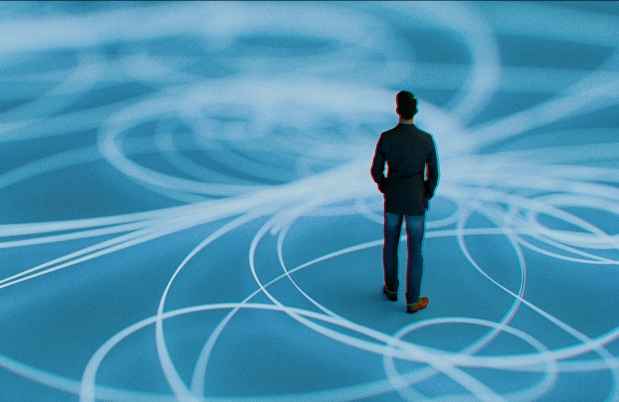 Figure stands on blue field of swirling lines