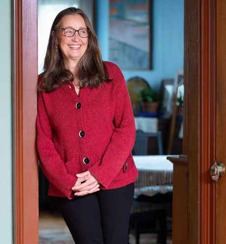 Participant Sandy smiling while standing in a doorway