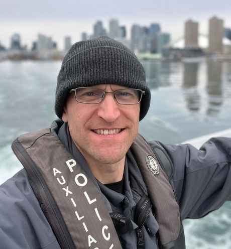 Participant Chris on a boat wearing a life jacket